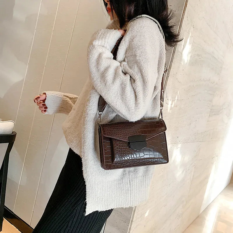 Vintage-style black PU leather crossbody bag with dimensions 20cm by 14cm by 7cm.