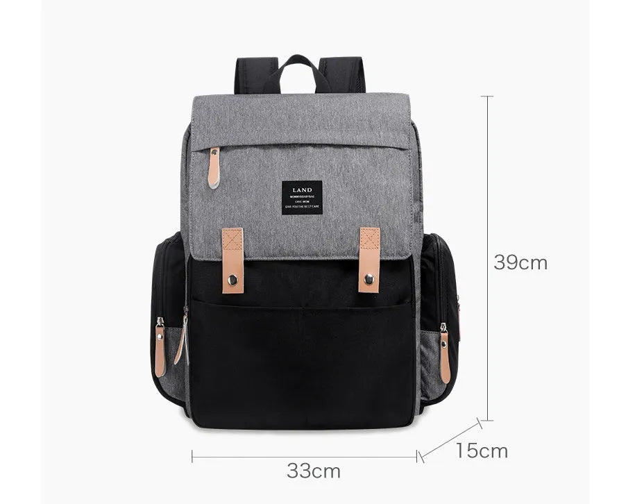 LAND Mommy large grey Oxford cloth diaper backpack with changing mat, showing front compartments.