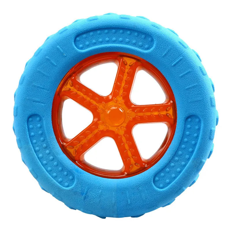 Set of three dog toys: a red ball, a blue barbell, and an orange tyre, floating in water.