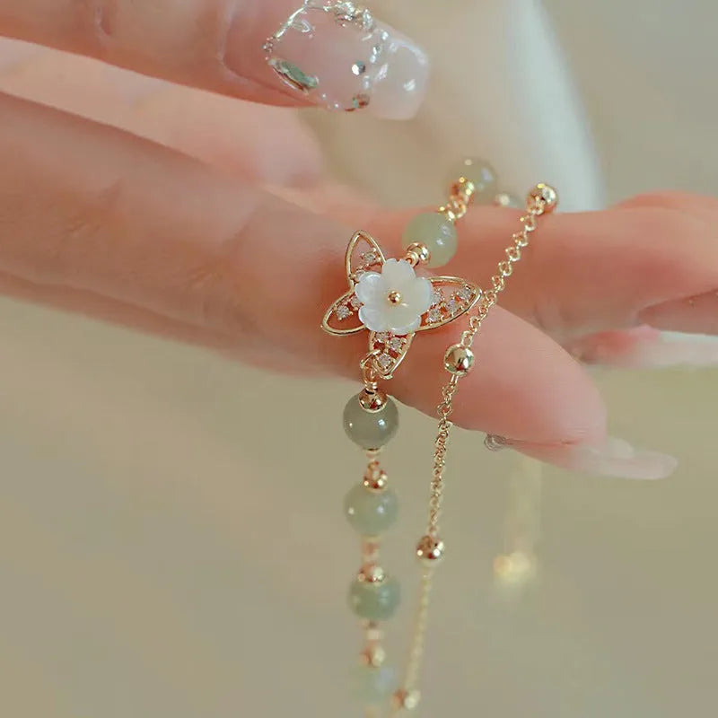 Yellow gold electroplated copper bracelet with shell flower butterfly and Hetian jade design for women