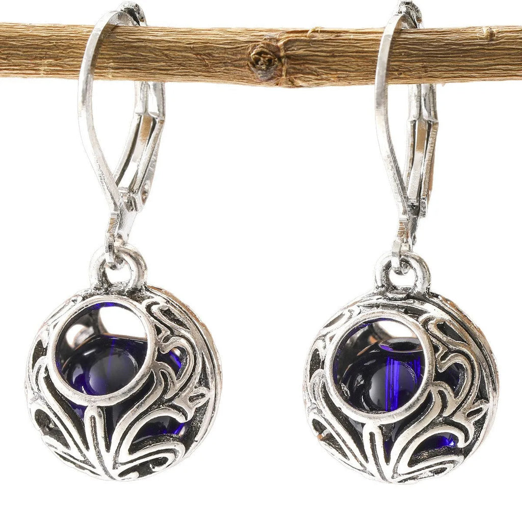 Vintage geometric silver tone pendant earrings with hollow blue gemstone setting