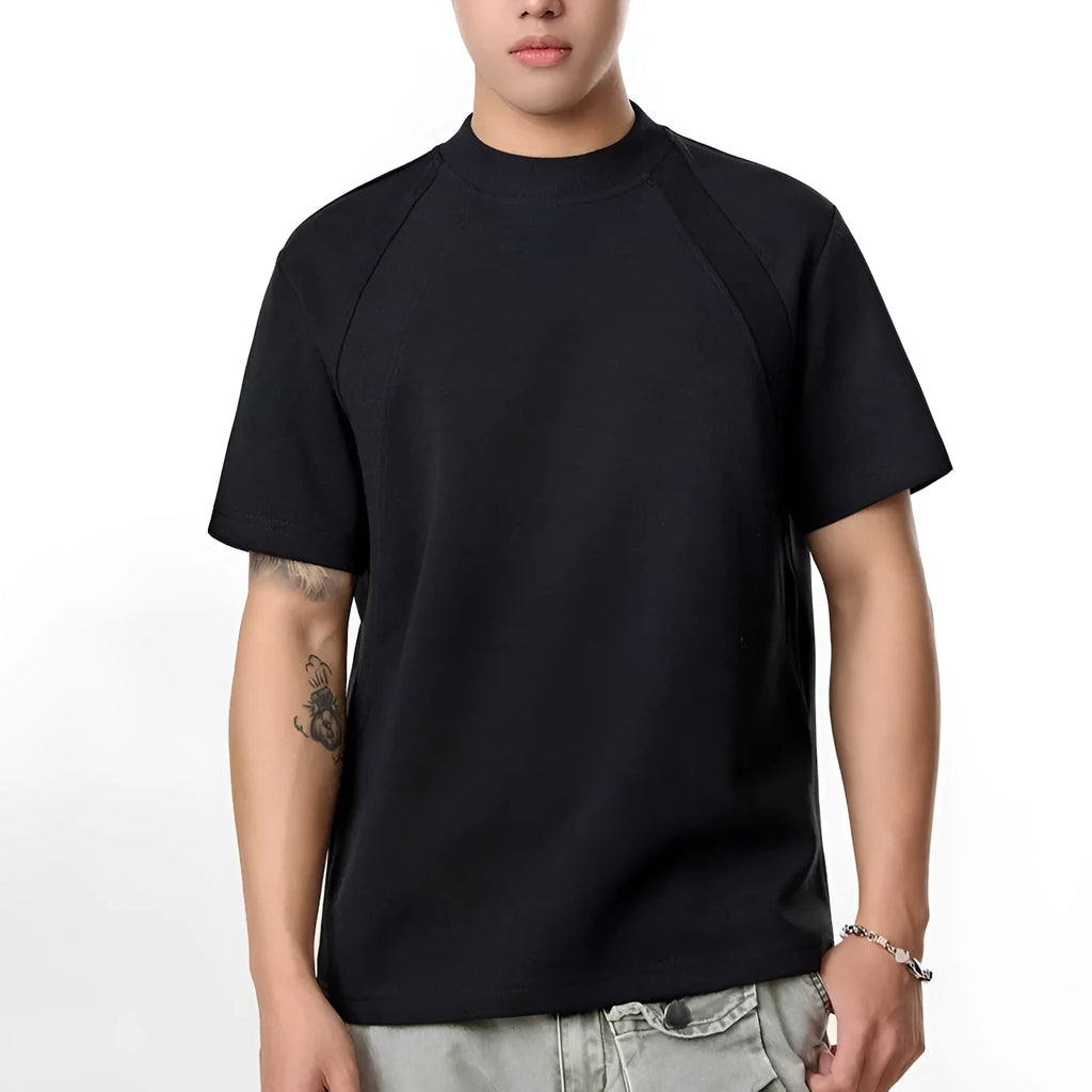 Man wearing a black loose-fit short sleeve top with visible air layer stitching texture.