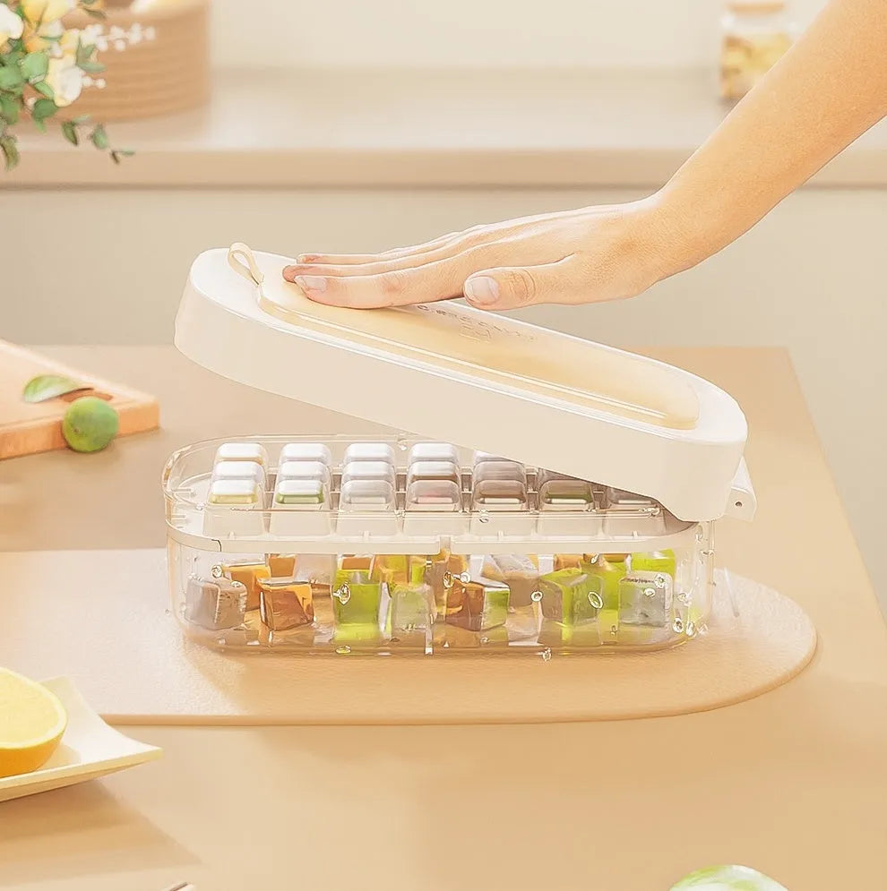 Blue high-capacity ice cube tray with integrated storage for an ice shovel.