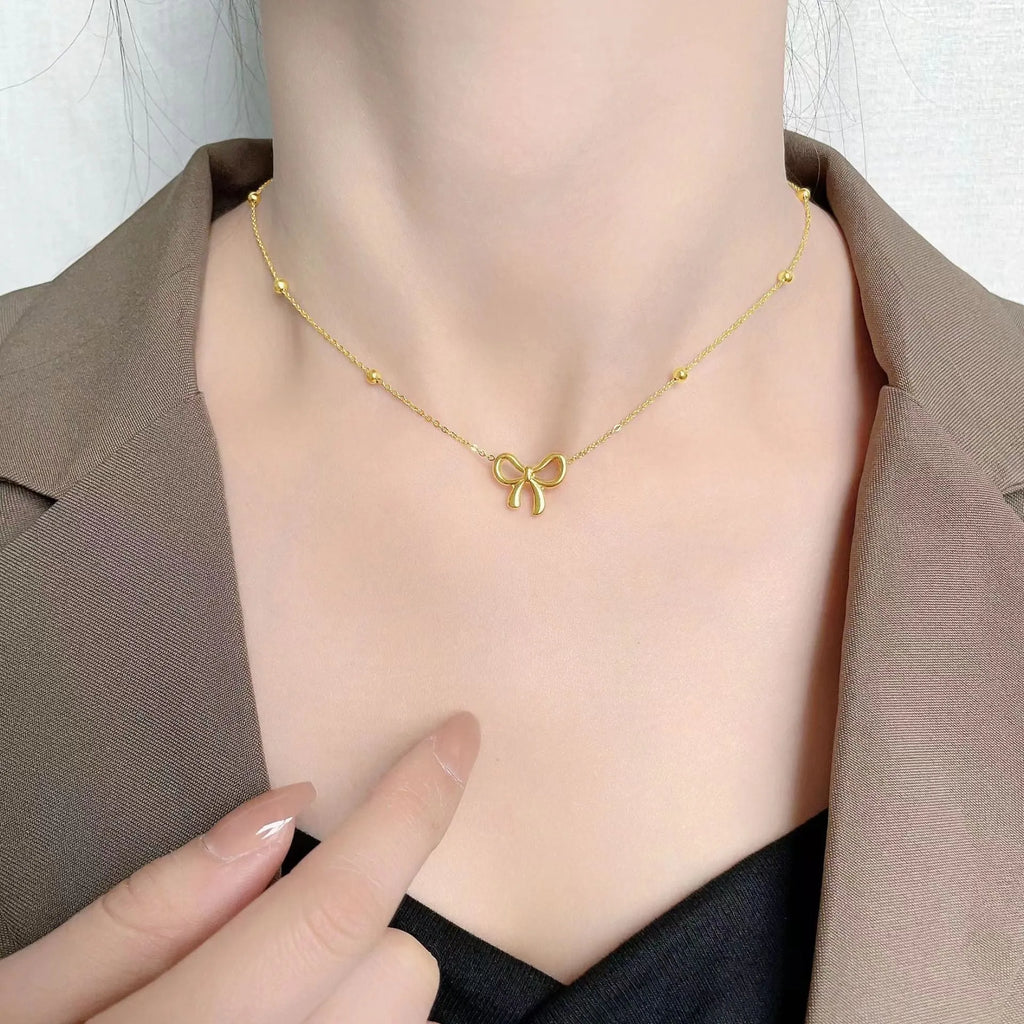 Gold titanium steel bow necklace on cross chain, adjustable 41-50 cm, for women's fashion