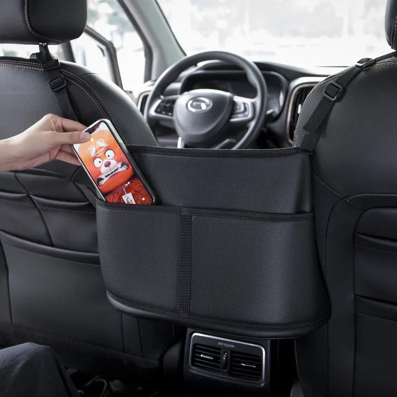 Black leather car seat net pocket with sports carbon fibre pattern hanging in middle of seat