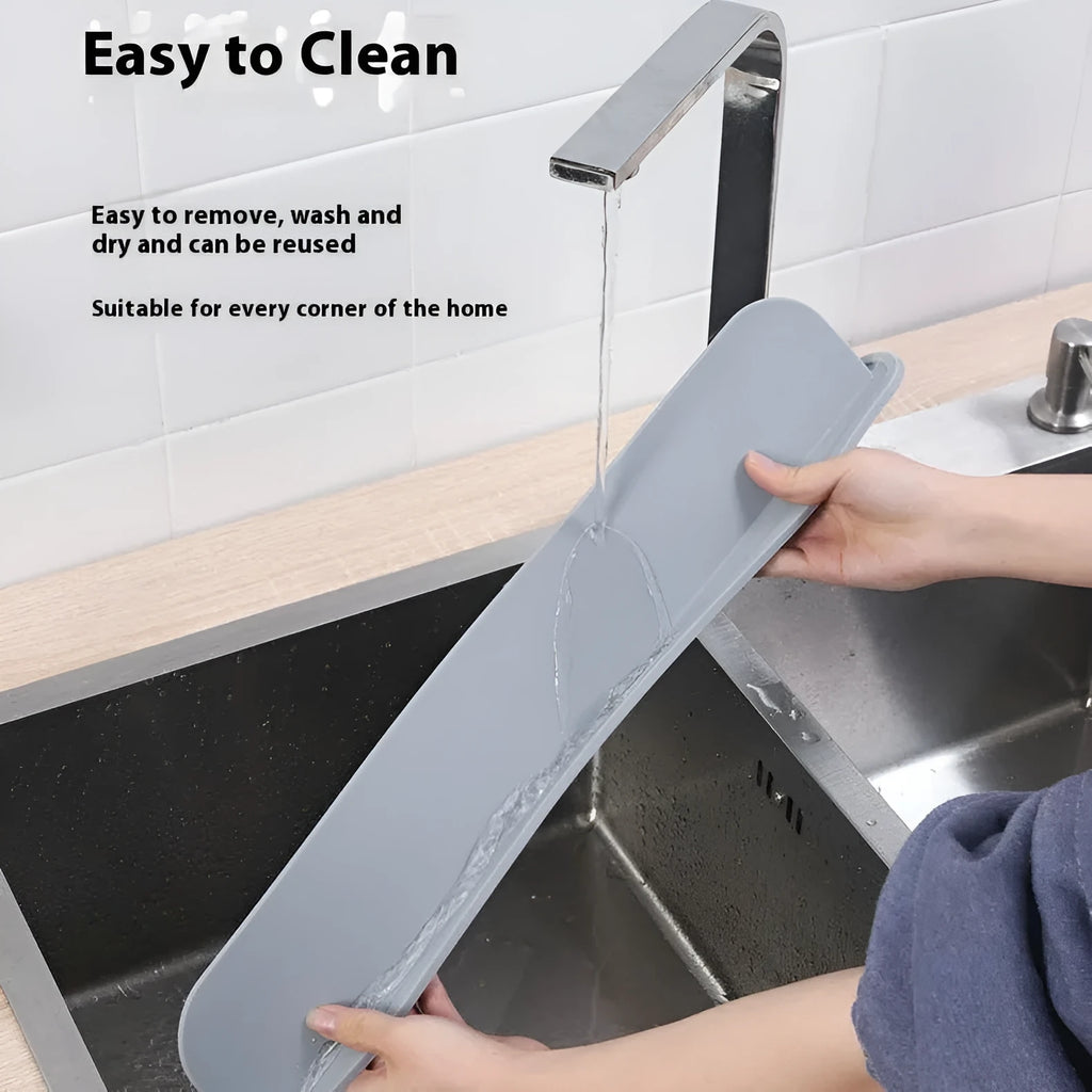 Thick grey silicone sink splash guard fitted on a kitchen sink edge