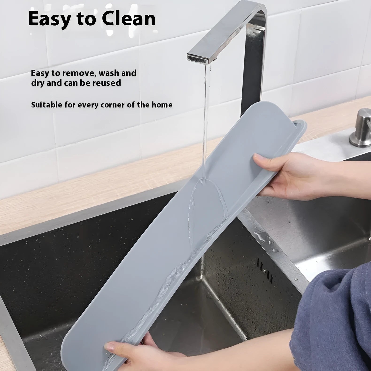 Thick grey silicone sink splash guard fitted on a kitchen sink edge