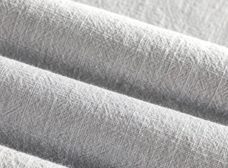 Man wearing a loose fit, light grey linen casual shirt.