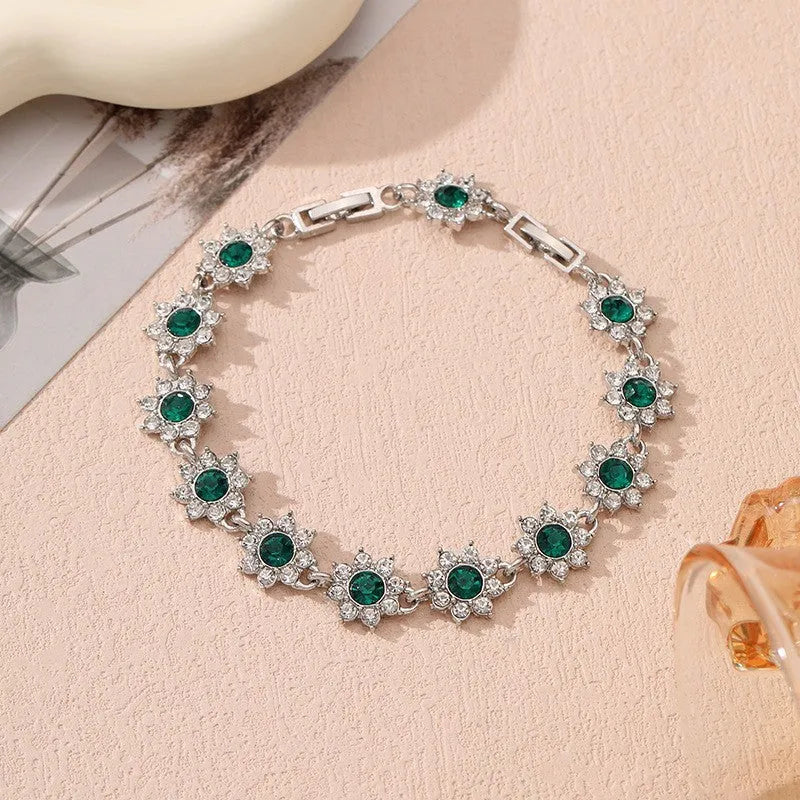 Electroplated zinc alloy flower bracelet in a choice of gold or silver finishes with coloured gemstone designs.