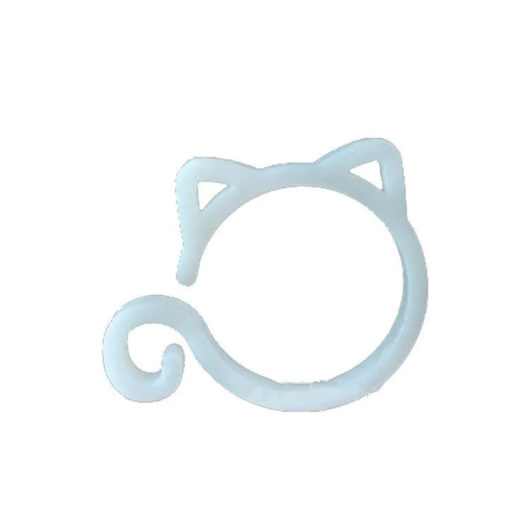 Small red cat-shaped plastic clip for plant support on a green leaf.