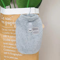 Blue coral fleece jacket for a dog, showing front leg openings and fluffy texture.