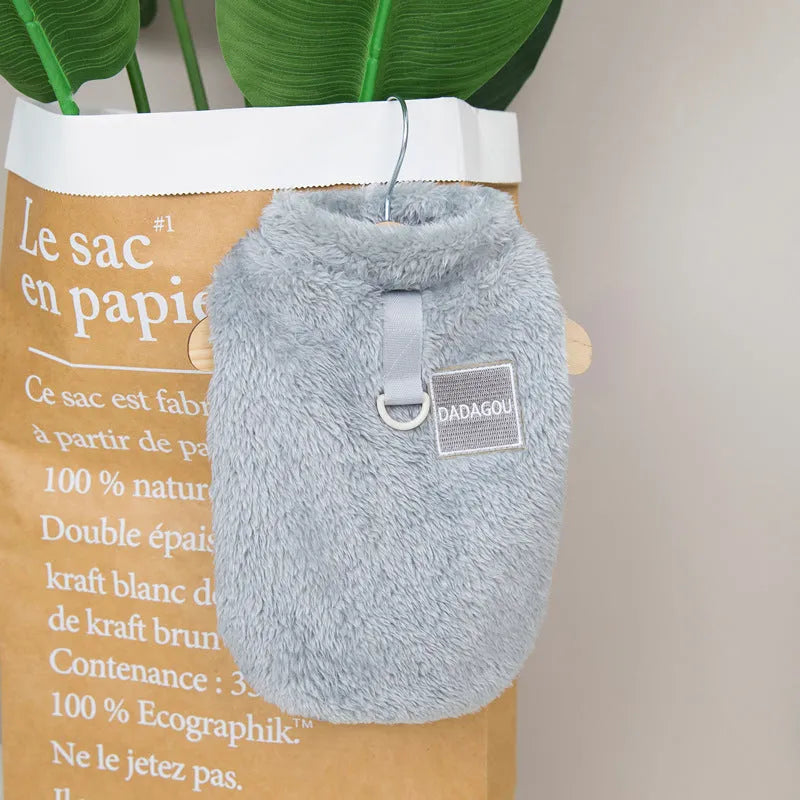 Blue coral fleece jacket for a dog, showing front leg openings and fluffy texture.
