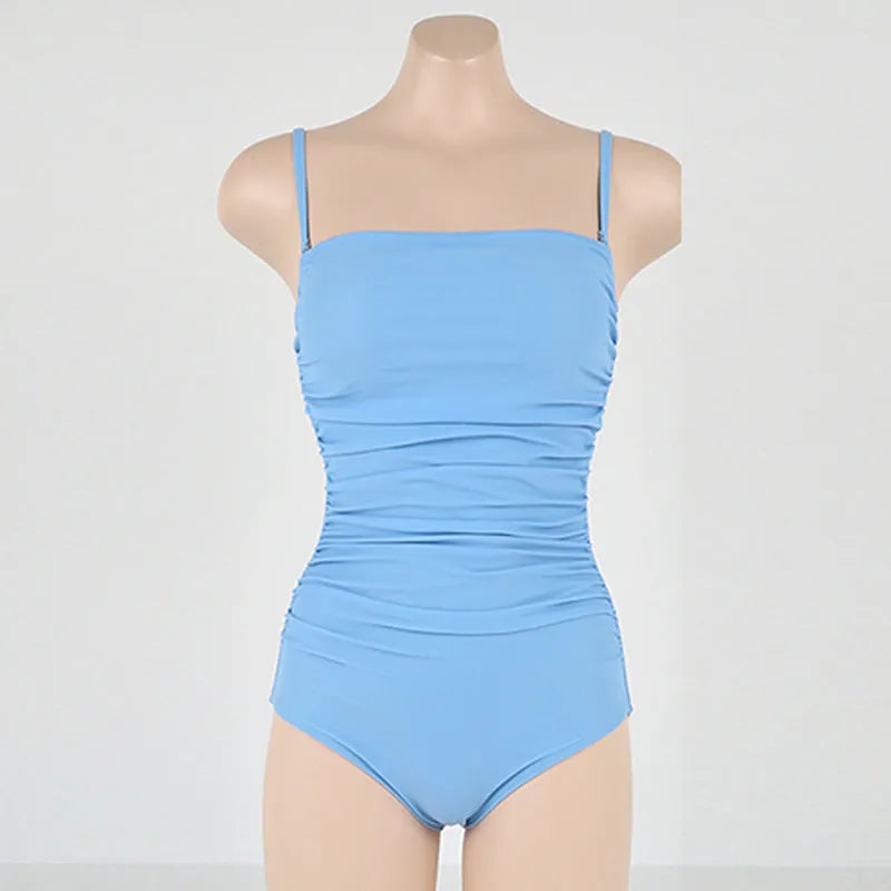 Women's sling style one-piece swimsuit with belly pleats in solid colour options