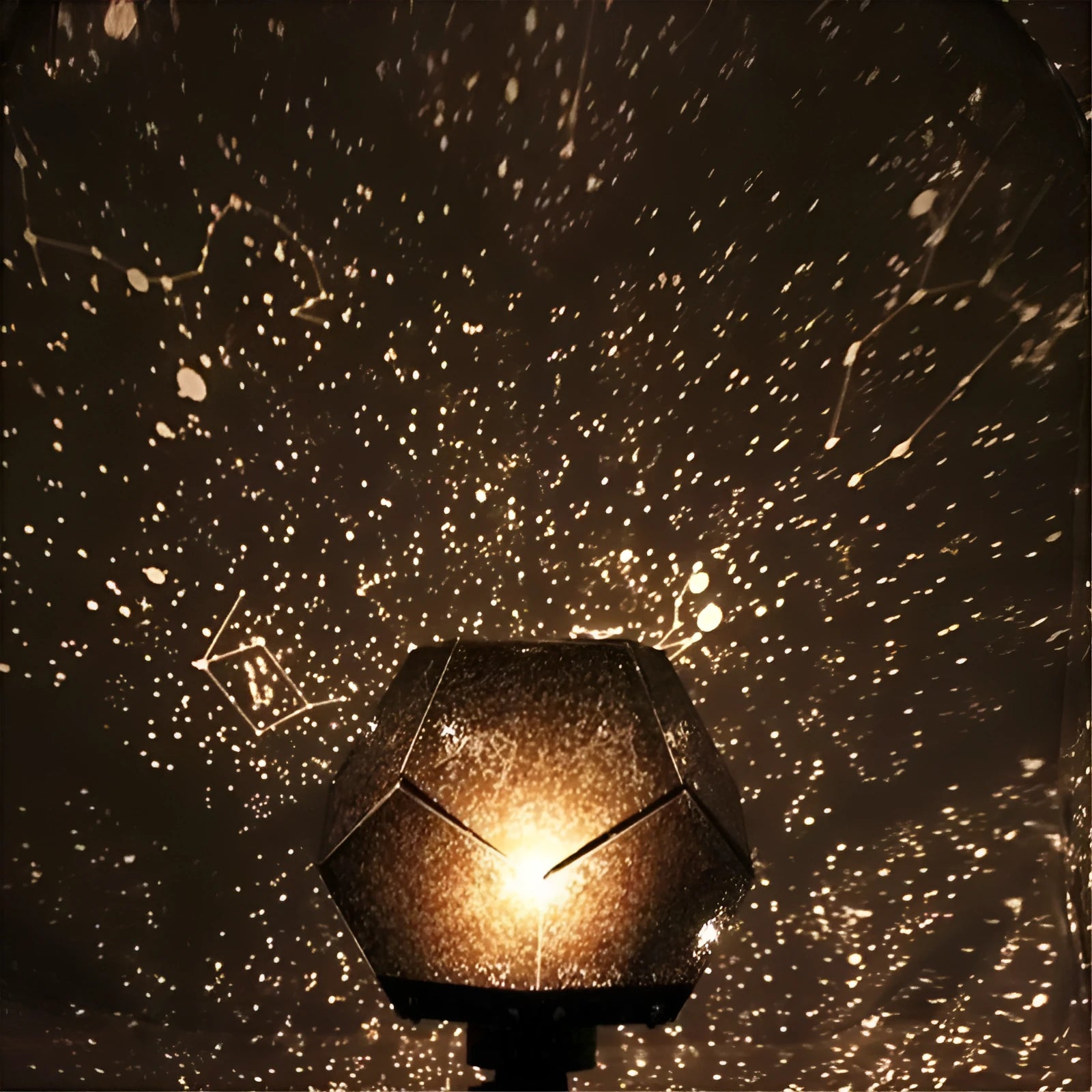 LED starry sky projector night lamp showing constellation projection on a bedroom ceiling.