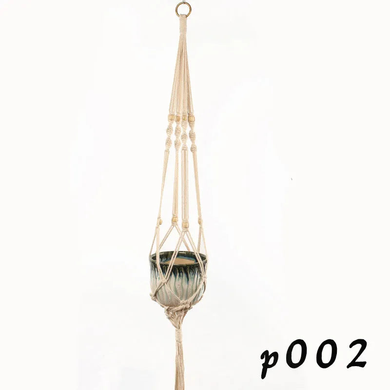 Natural cotton rope woven wall hanging planter holding a small green plant.