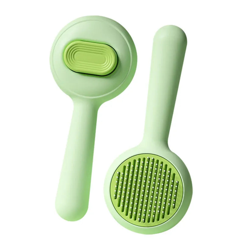 Green and yellow non-slip handle cat grooming brush with stainless steel comb teeth.