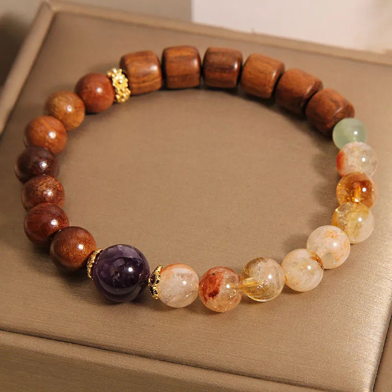 Women's adjustable crystal bracelet with yellow tower crystal, ebony amethyst, pearls, and rhinestones.