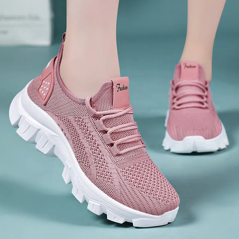 Men's white Flyknit sneakers with a thick PVC sole and round toe on a plain background.