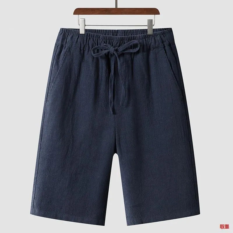 Men's linen shorts in loose cropped design with elastic waistband, shown in available colours