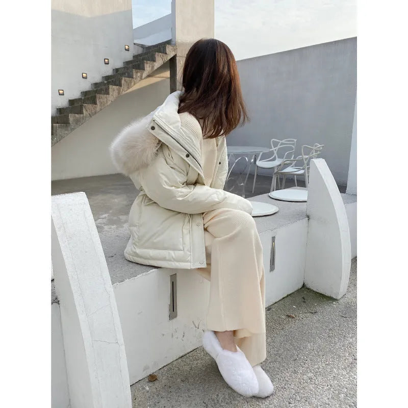 Women's cream white high waist wide-leg knitted trousers with a long mopping hem and elastic waistband.