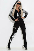 Black women's casual suit with wings print, featuring a hooded zip-up top and trousers.