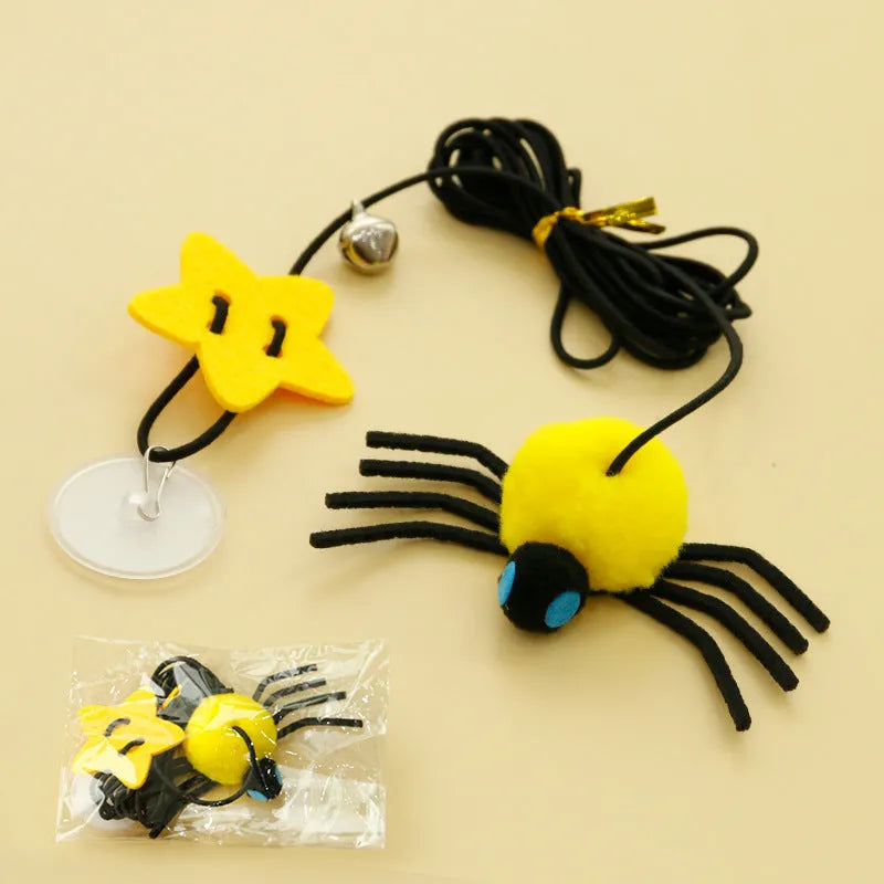 Red cat door hanging toy with elastic rope, feathers, bell, and spider attachments for interactive play