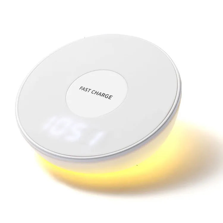 White wireless charger with digital clock display and night light feature on a bedside table