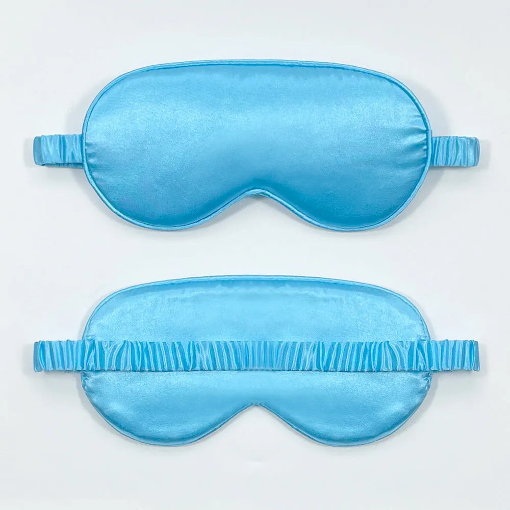 Double-sided Rayon elastic satin sleep mask shown in multiple colour options including sky blue, black, wine red, and light pink.