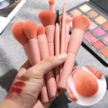 Ten-piece wooden handle makeup brush set with nylon bristles including powder, foundation, and double-ended brushes