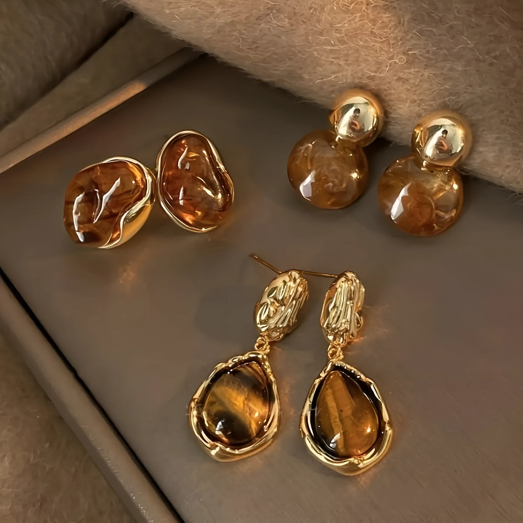 Three pairs of geometric alloy ear rings with tassel elements in different electroplated finishes