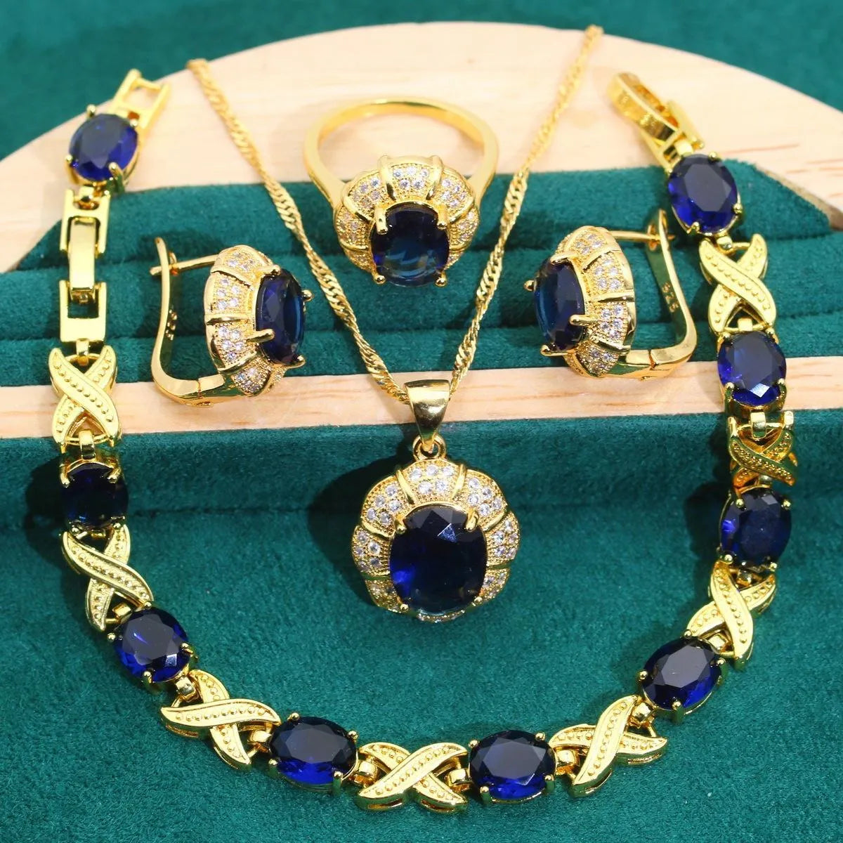 Gold plated jewellery set with multi-colour cubic zirconia stones, featuring a necklace, earrings, a ring, and a bracelet.