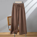 Women's straight-leg casual trousers in apricot colour with elastic and lace-up drawstring waistband.