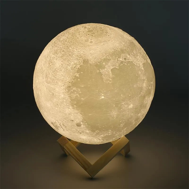 3D printed moon lamp showing detailed craters, on wooden stand with touch metal ring at base.