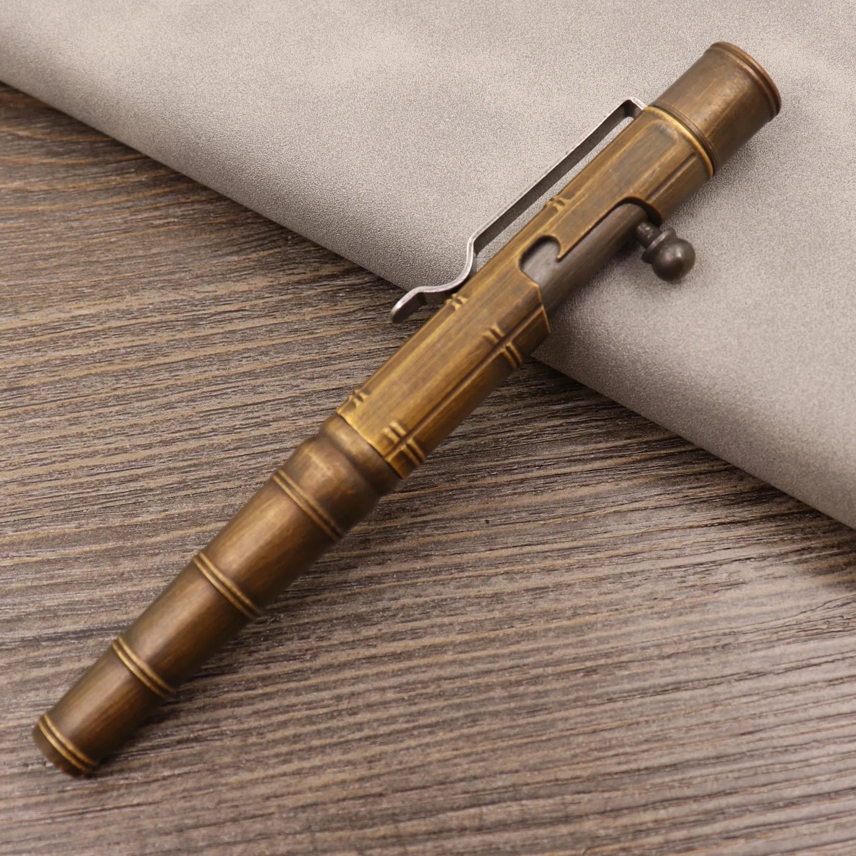 Brass tactical pen with bolt-action mechanism and retro brushed finish