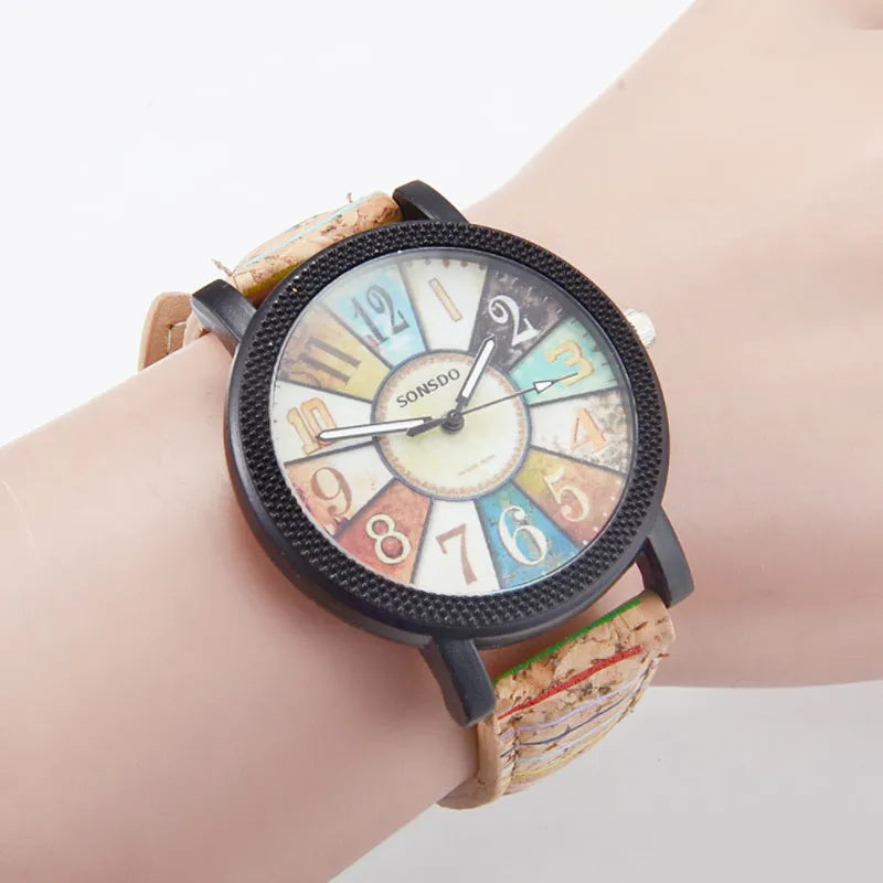 Vintage style women's leather strap quartz watch with round 37mm dial and stainless steel buckle.
