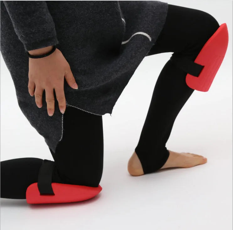 A pair of black EVA foam knee pads for gardening, showing their rectangular shape and textured surface.