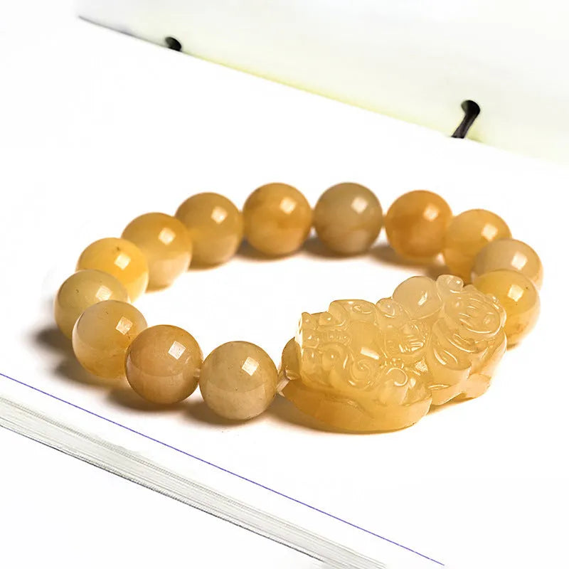 Carved Jinsi Jade money bracelet in Golden Thread Jade colour showing texture and bead detail.