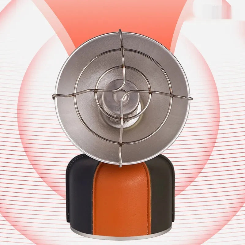 Black and orange portable camping heater stove with automatic ignition on a table.
