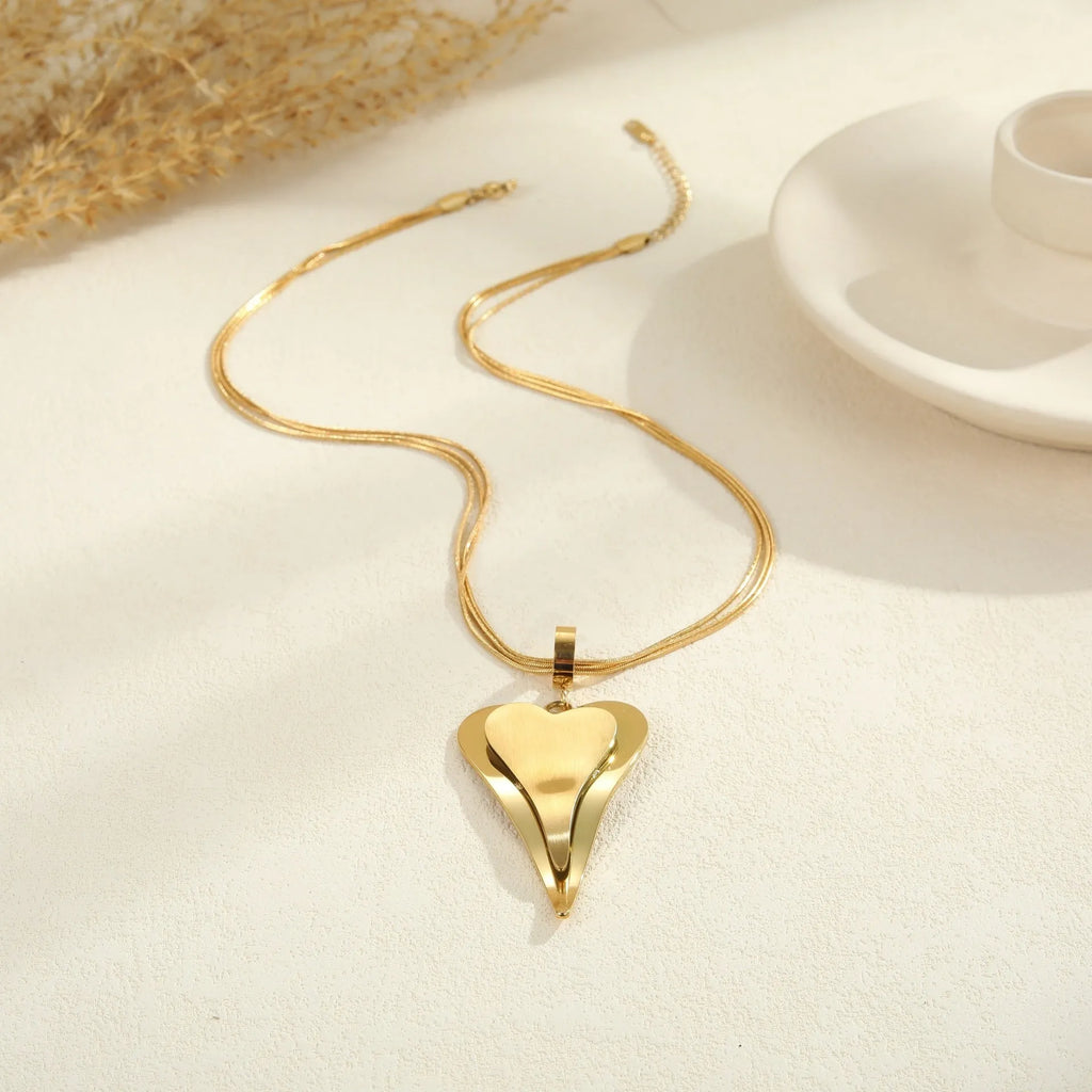 Gold stainless steel necklace with double heart pendant on snake bones chain
