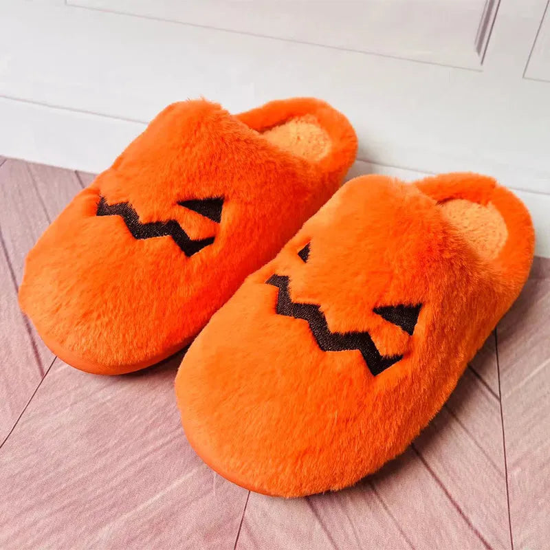 Orange pumpkin-themed plush slippers with a non-slip sole for indoor home wear.