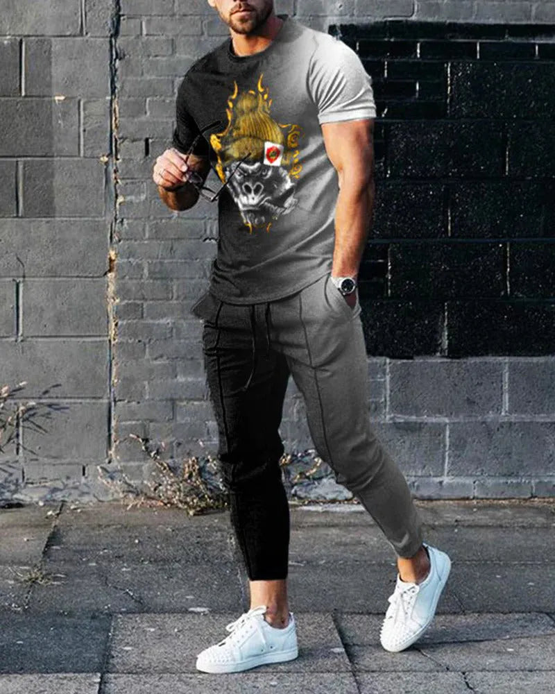 Man wearing a printed short-sleeve t-shirt and matching trousers from a cotton-like men's tracksuit set.