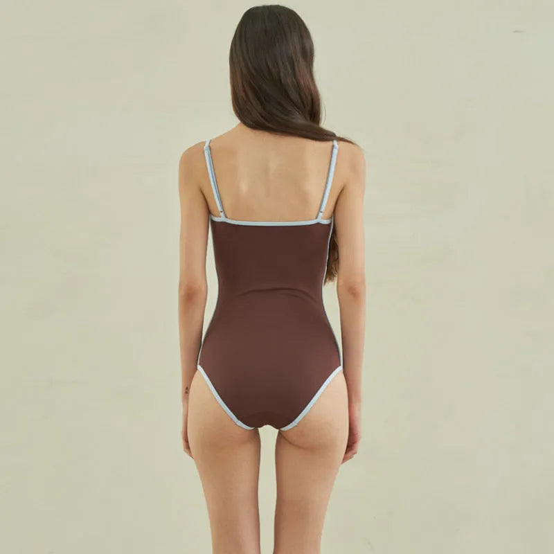 Brown women's one-piece swimsuit with triangle neckline on mannequin