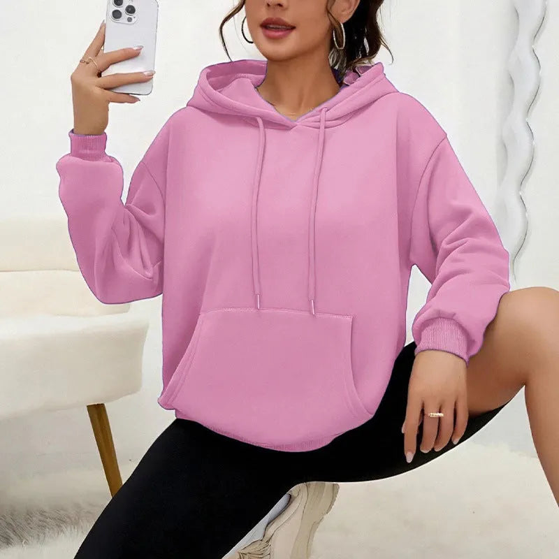 A loose-fitting women's long-sleeve sweatshirt with a drawstring pocket, shown in a solid colour.