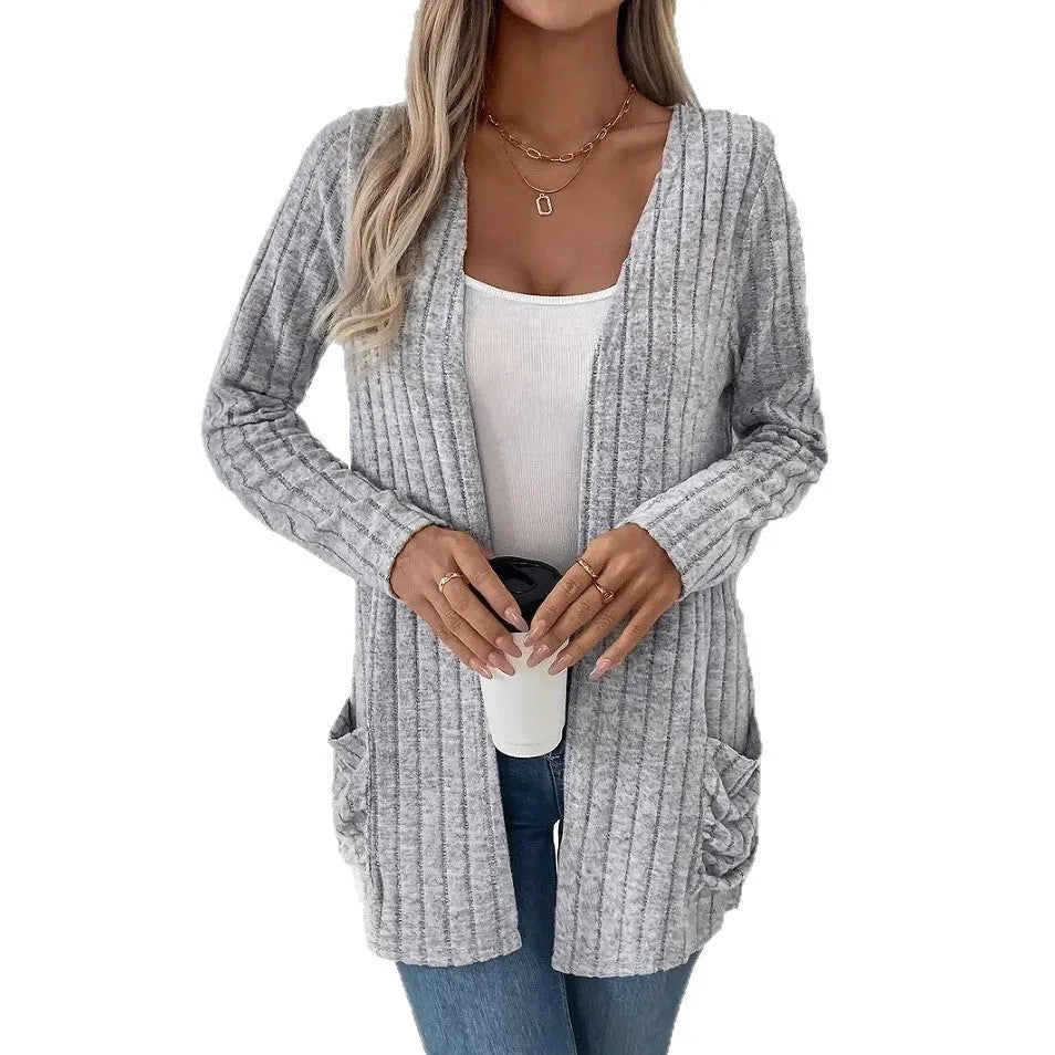 Grandma Grey loose fit long sleeve cardigan with two front pockets, shown on a hanger.