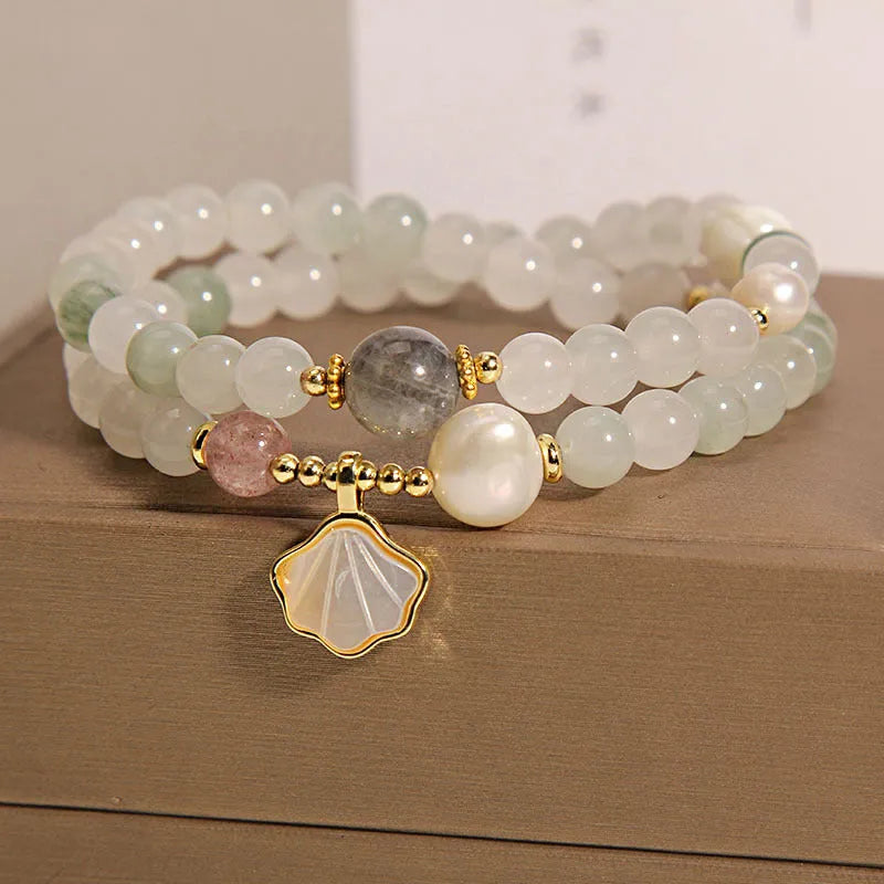 Women's crystal bracelet with an apricot leaf and jade shell pendant, gold-plated settings, and rhinestones.