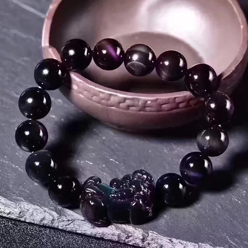 Natural ice colour eye obsidian crystal bracelet on an elastic band, showing bead detail.