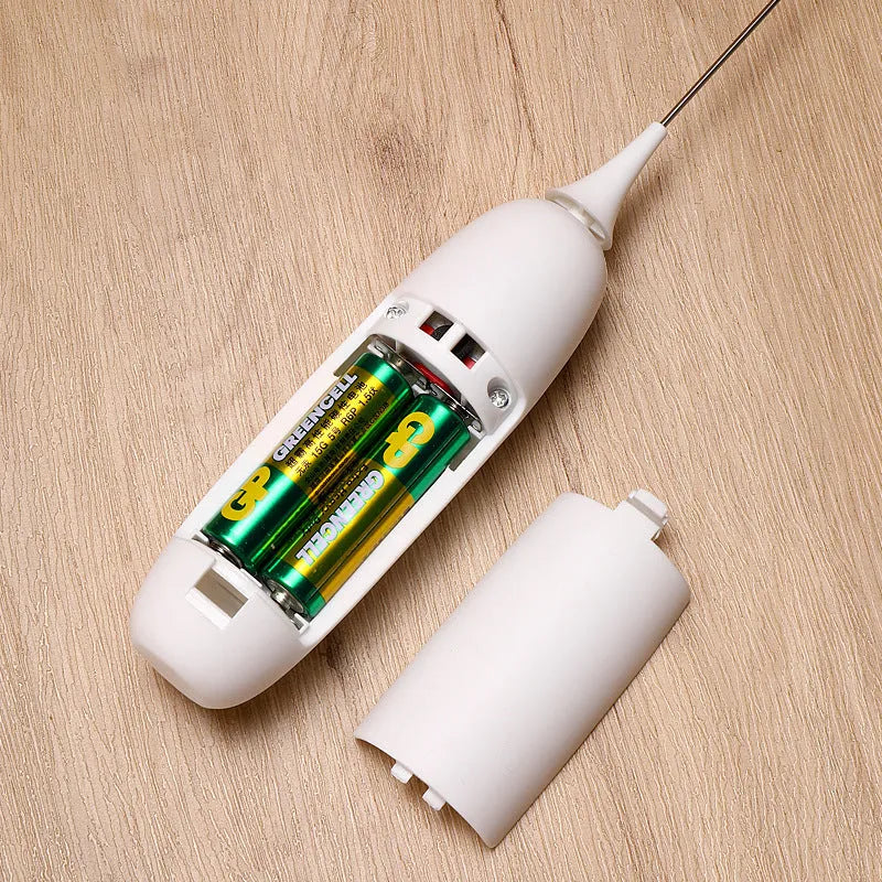 Handheld electric milk frother in black and white colours for making coffee and hot chocolate foam.