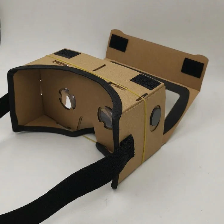 Pink and white folding cardboard VR glasses viewer for smartphones with 3D lenses and head strap.
