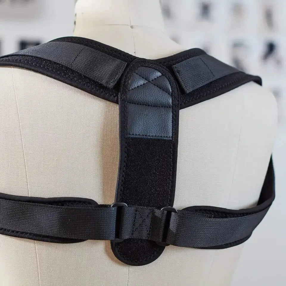 Black adjustable posture correction strap showing breathable fabric and adjustment mechanism