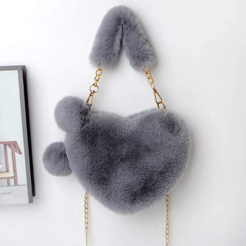 A soft plush heart-shaped women's handbag with a zipper and a detachable shoulder strap in a choice of 14 colours.